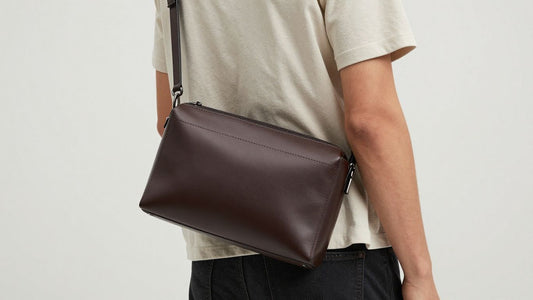 Man wearing a leather crossbody bag.