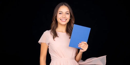 Woman in a stylish graduation dress smiling.